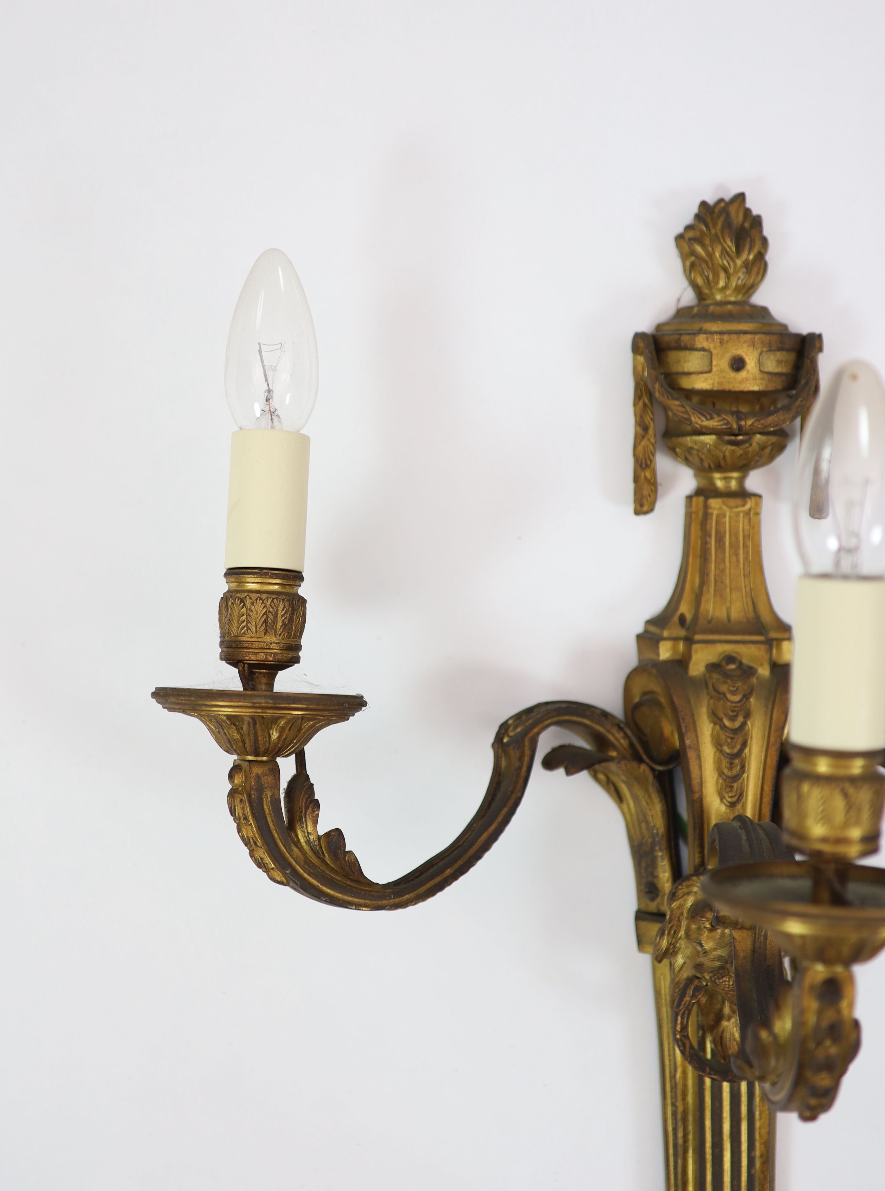 A pair of Louis XVI style ormolu three branch wall lights H 55cm. W 45cm.